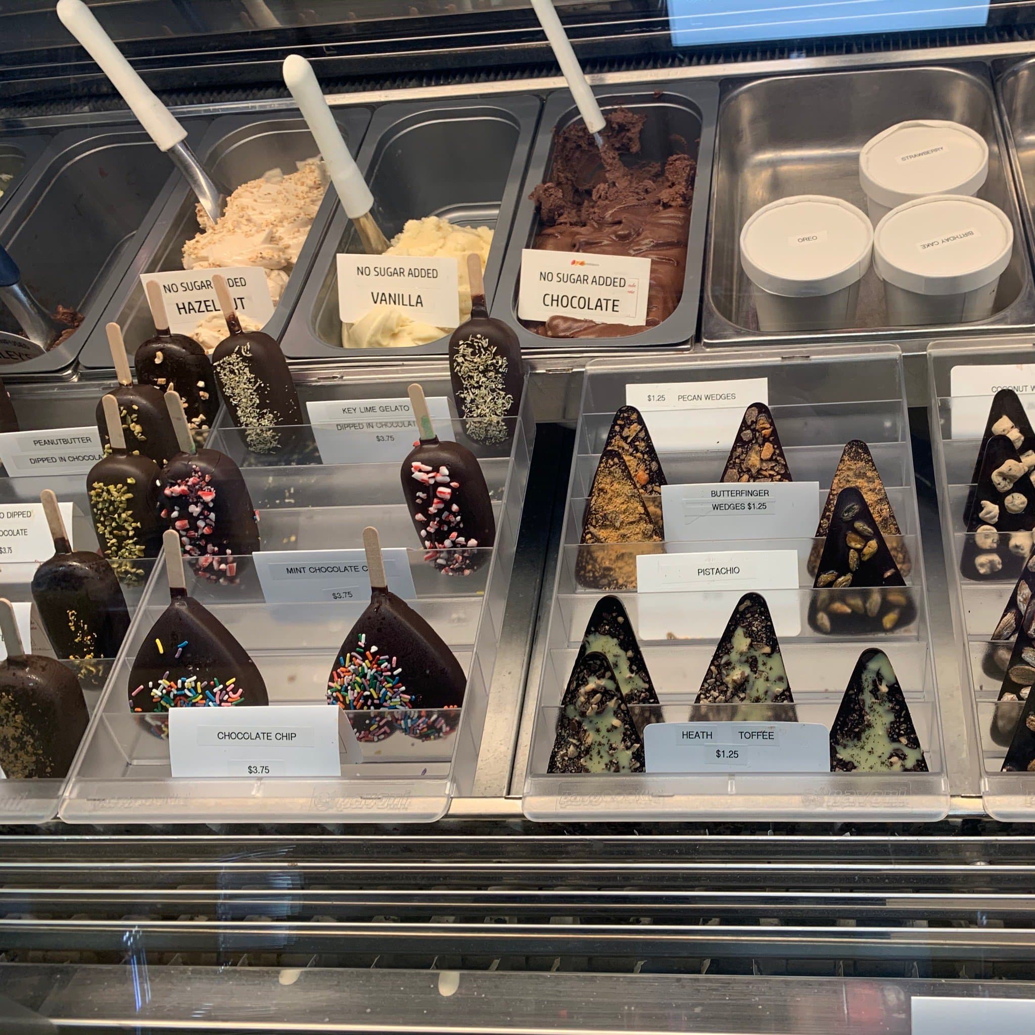 The gelato case at Ciao Gelato, full of pistachio, raspberry, chocolate, and lemon flavors